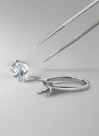An engagement ring setting with a loose round brilliant diamond